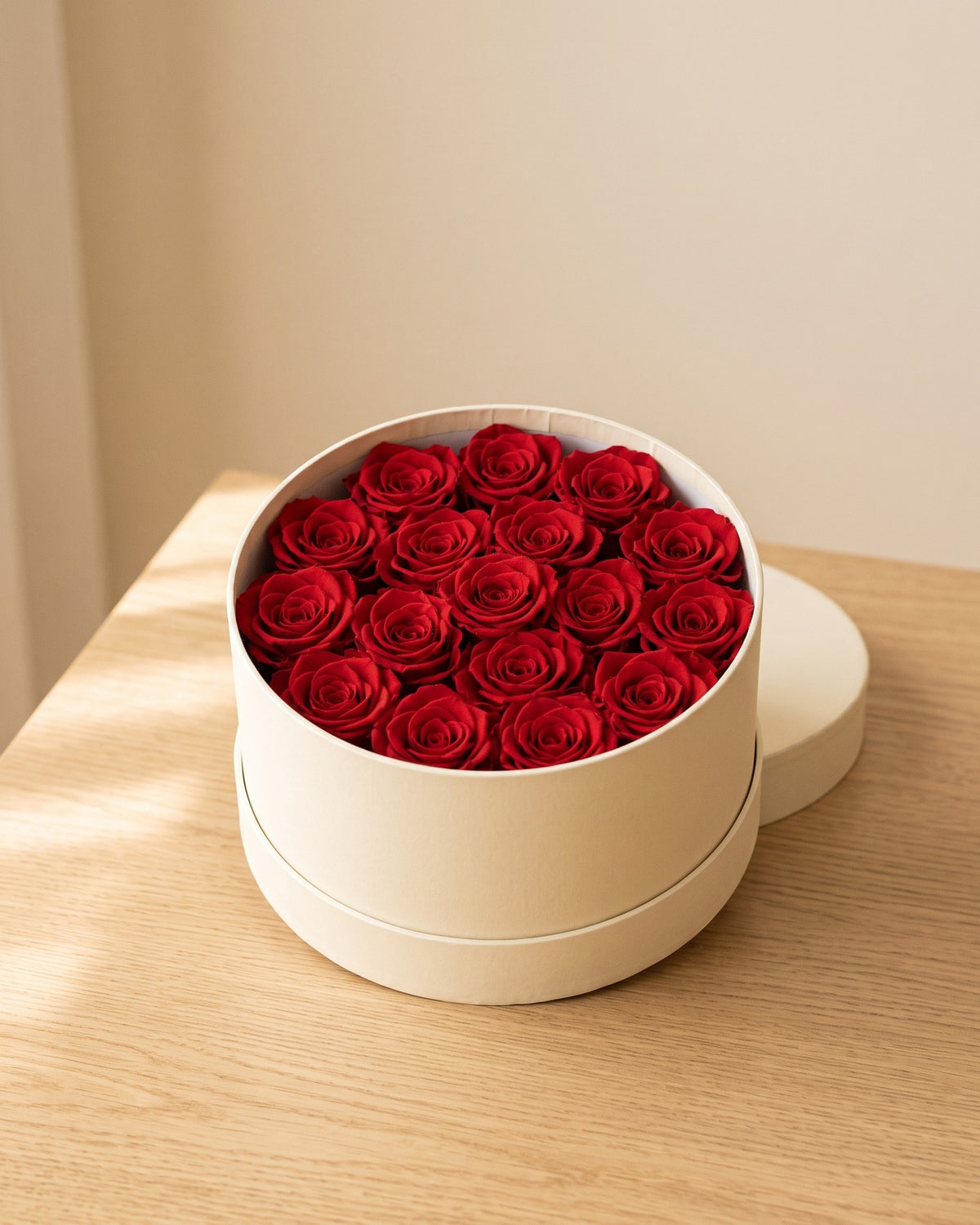 Cabezas de rosa preservada roja en una caja redonda de regalo, ambientada. Caja de regalo no incluida.